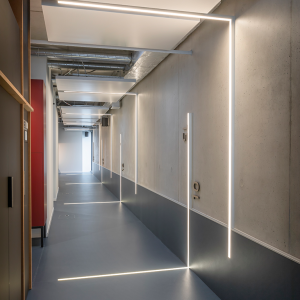 Wall-mounted linear profile for corridor lighting